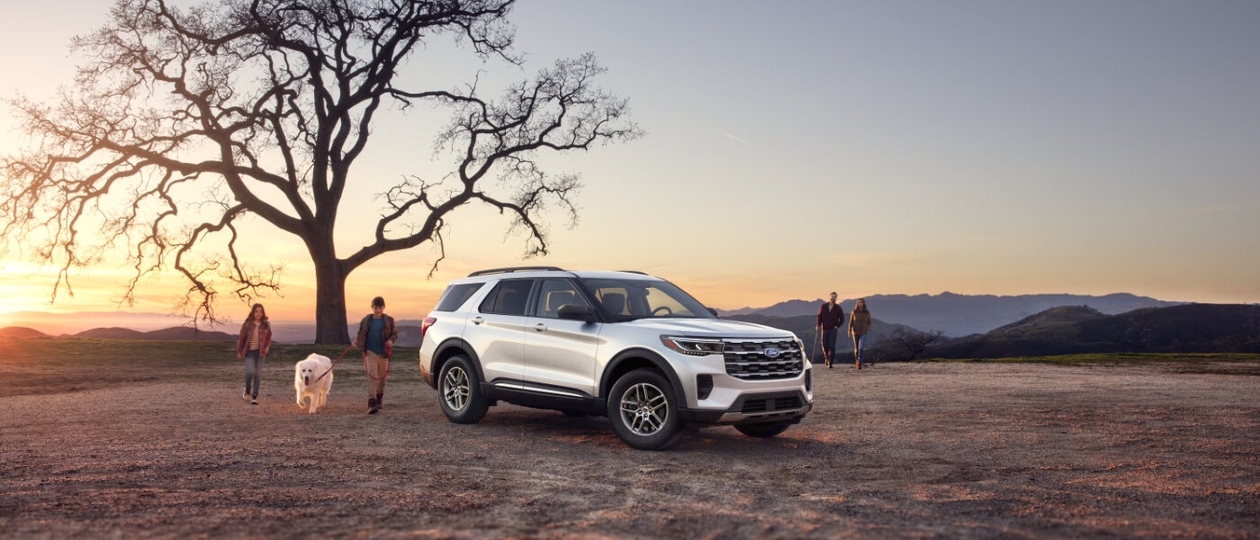 2026 Ford Explorer parked in field with family