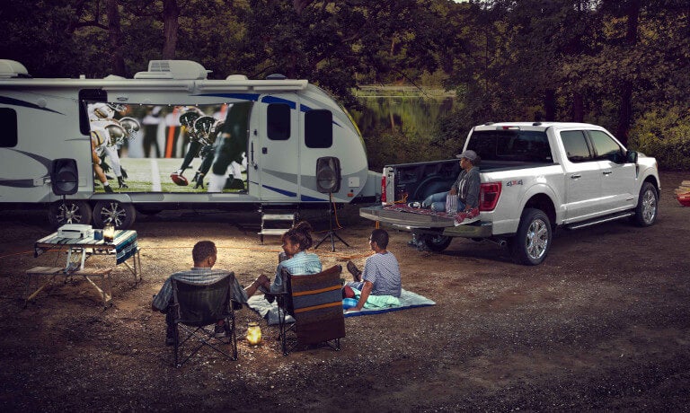 2026 Ford F-150 parked with RV and family
